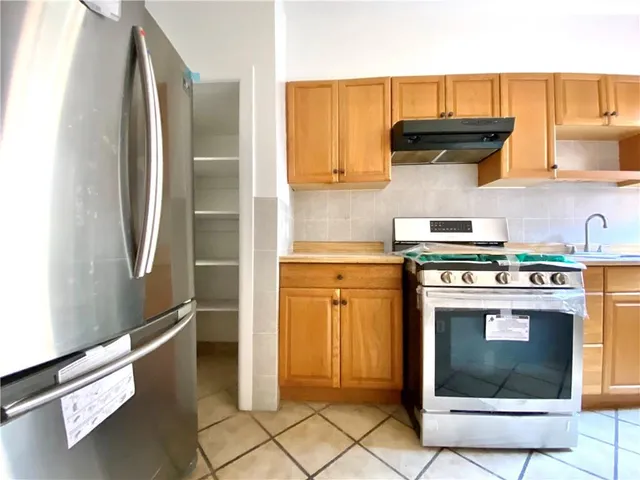 a kitchen with a stove a sink and a refrigerator