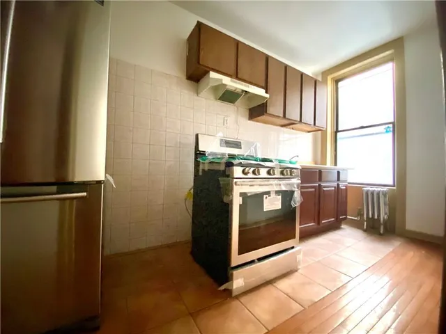 a kitchen with a sink stove and refrigerator