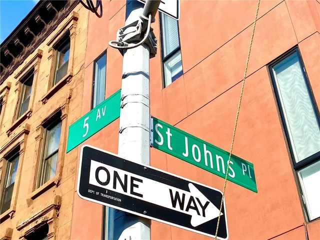 a large bedroom with a bed and wooden floor