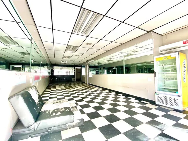 a view of an empty room with a fireplace and a window