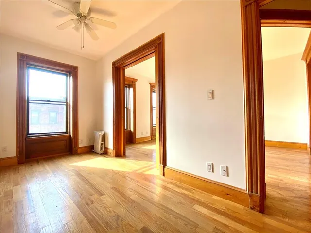 a view of an empty room with a fireplace and a window