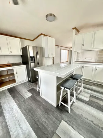 a kitchen with a sink appliances and cabinets