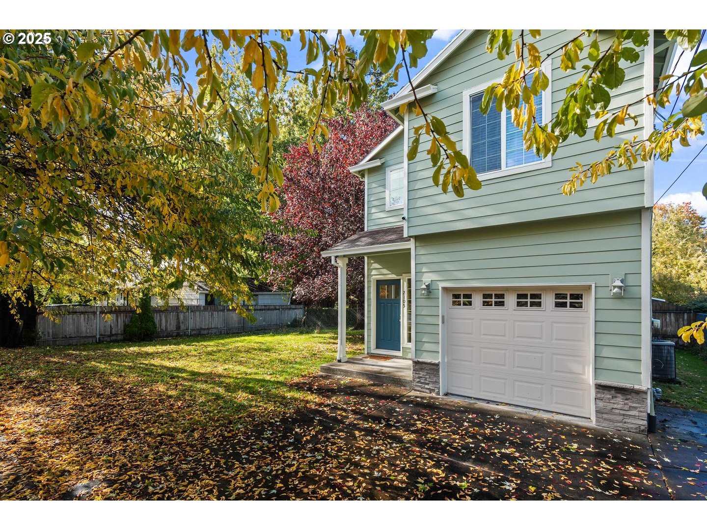 a view of a house with a yard and garage