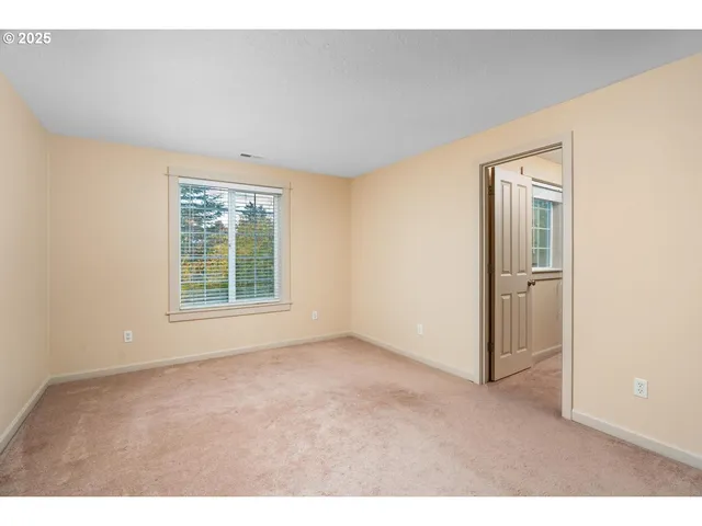 an empty room with windows and closet