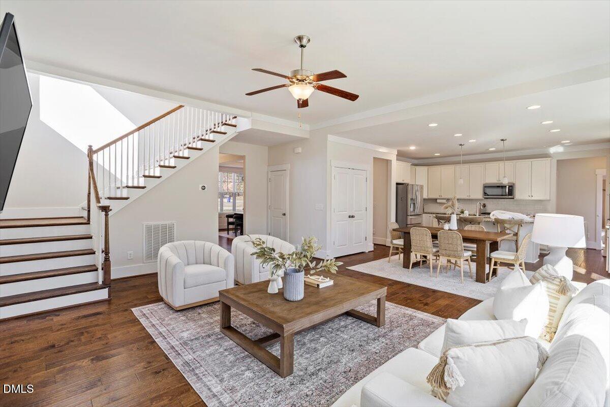 2301 Greenbrook Lane Durham, NC 27705 - Photo 18 of 42 a living room with furniture kitchen view and a chandelier