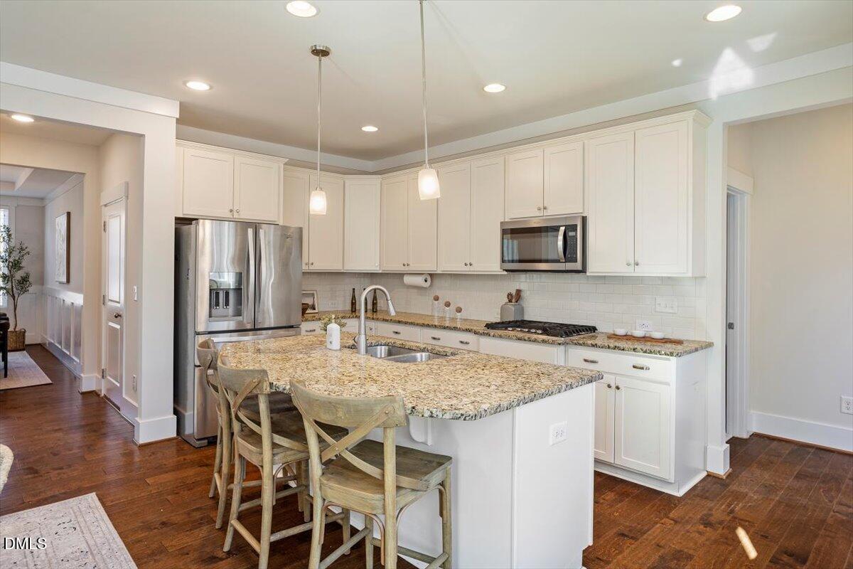 2301 Greenbrook Lane Durham, NC 27705 - Photo 22 of 42 a kitchen with a center island and a refrigerator