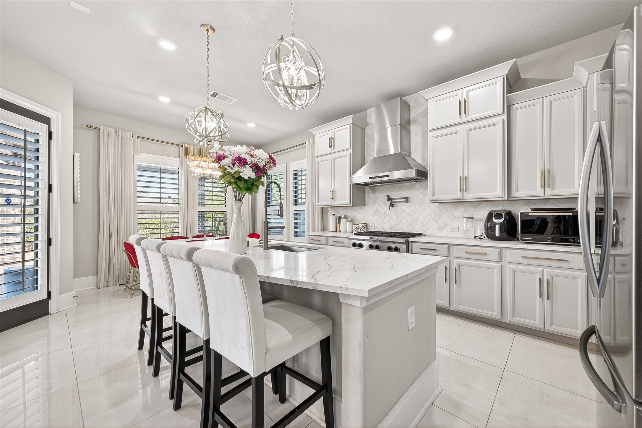 1122 Thyme Rise Lane Richmond, TX 77406 - Photo 19 of 50 a kitchen with stainless steel appliances granite countertop a stove a sink dishwasher a dining table and chairs with wooden floor