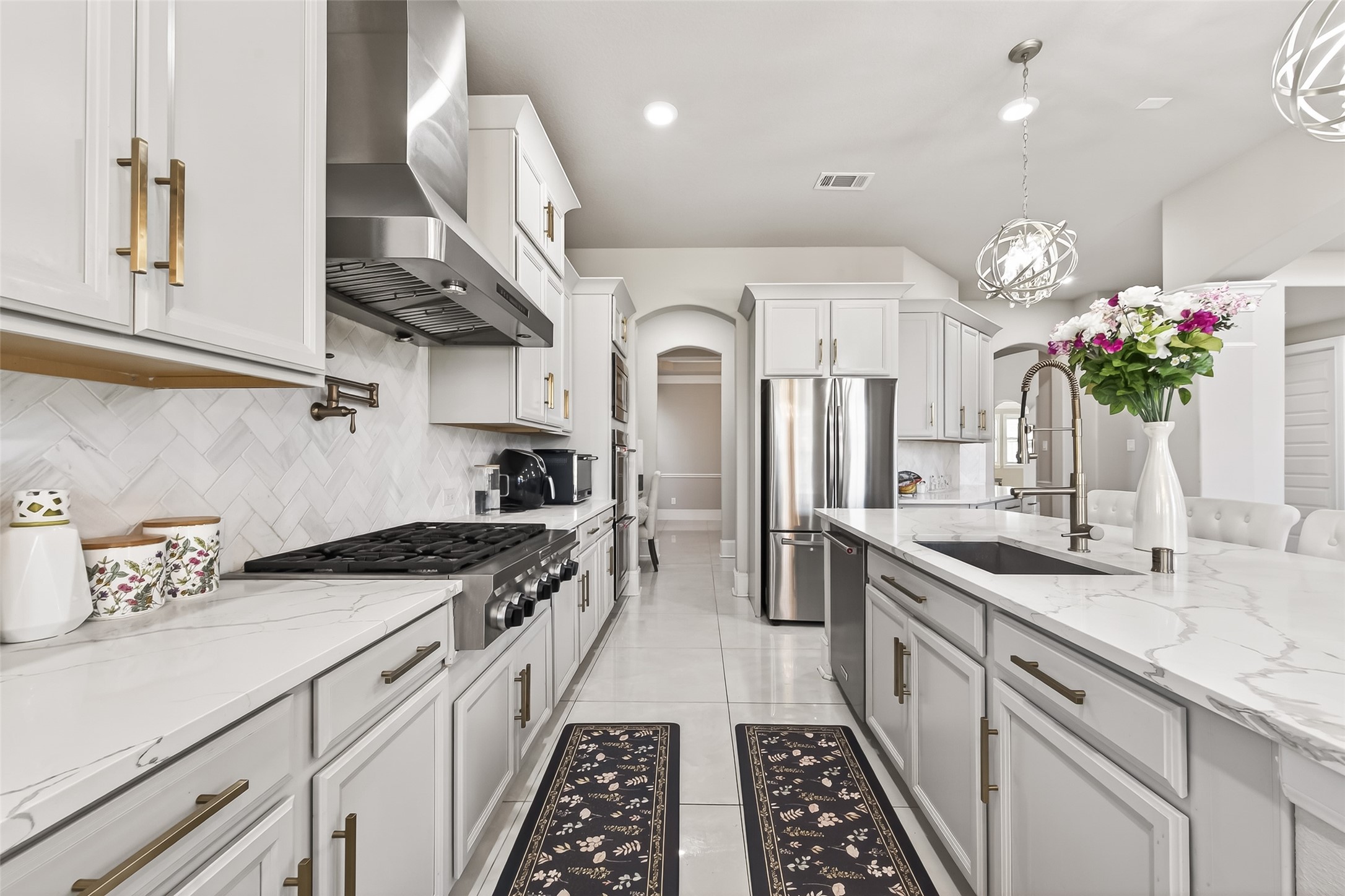 1122 Thyme Rise Lane Richmond, TX 77406 - Photo 23 of 50 a kitchen with granite countertop a sink stove and cabinets