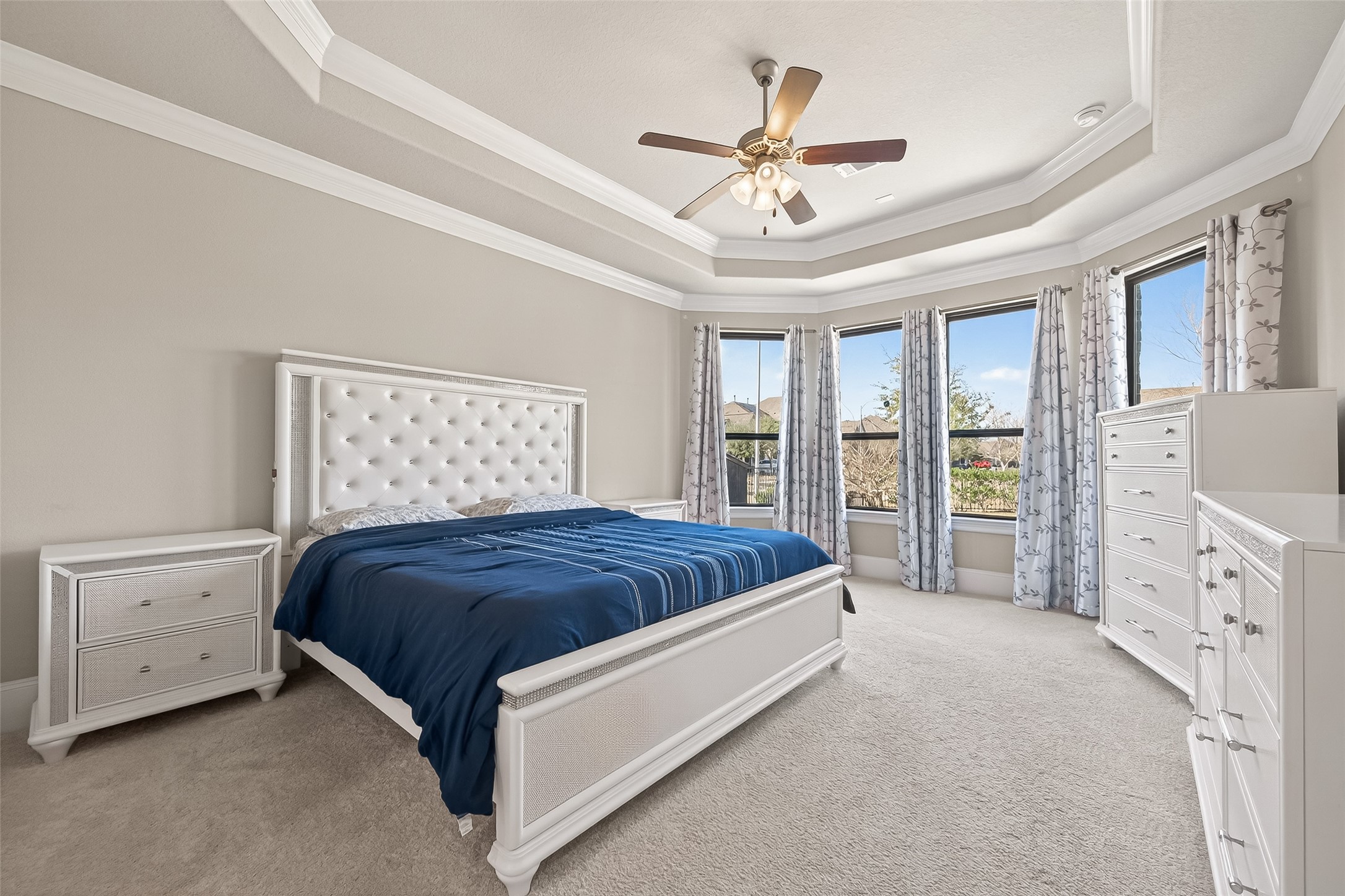 1122 Thyme Rise Lane Richmond, TX 77406 - Photo 27 of 50 a spacious bedroom with a large bed and a chandelier