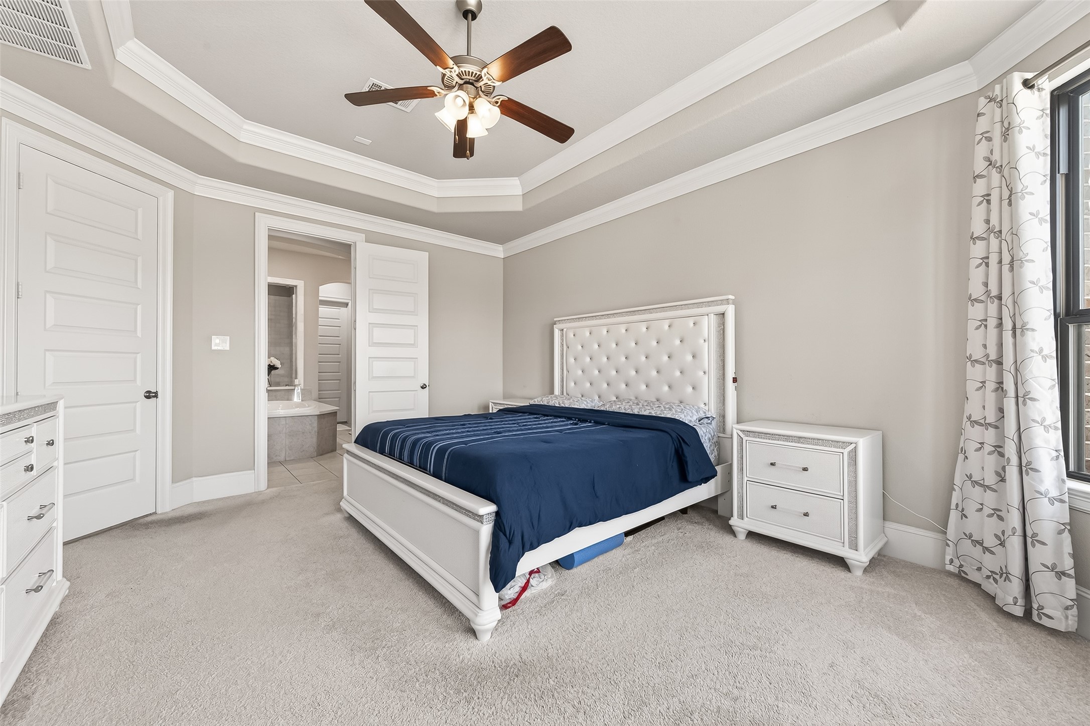 1122 Thyme Rise Lane Richmond, TX 77406 - Photo 28 of 50 a spacious bedroom with a bed and a chandelier