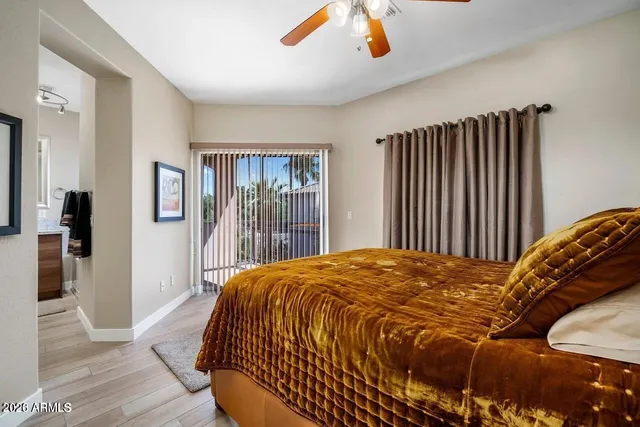 a bedroom with a large bed and a chandelier