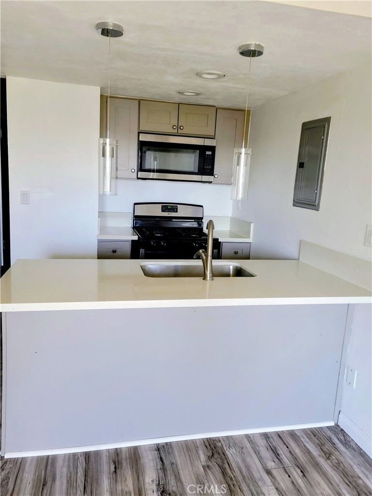 2255 Cahuilla Street, Unit 68 Colton, CA 92324 - Photo 11 of 30 a kitchen with a sink a microwave and cabinets