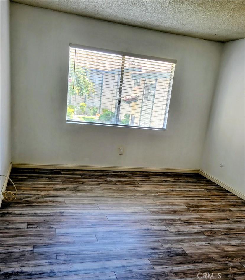 2255 Cahuilla Street, Unit 68 Colton, CA 92324 - Photo 14 of 30 a view of a room with wooden floor and a window