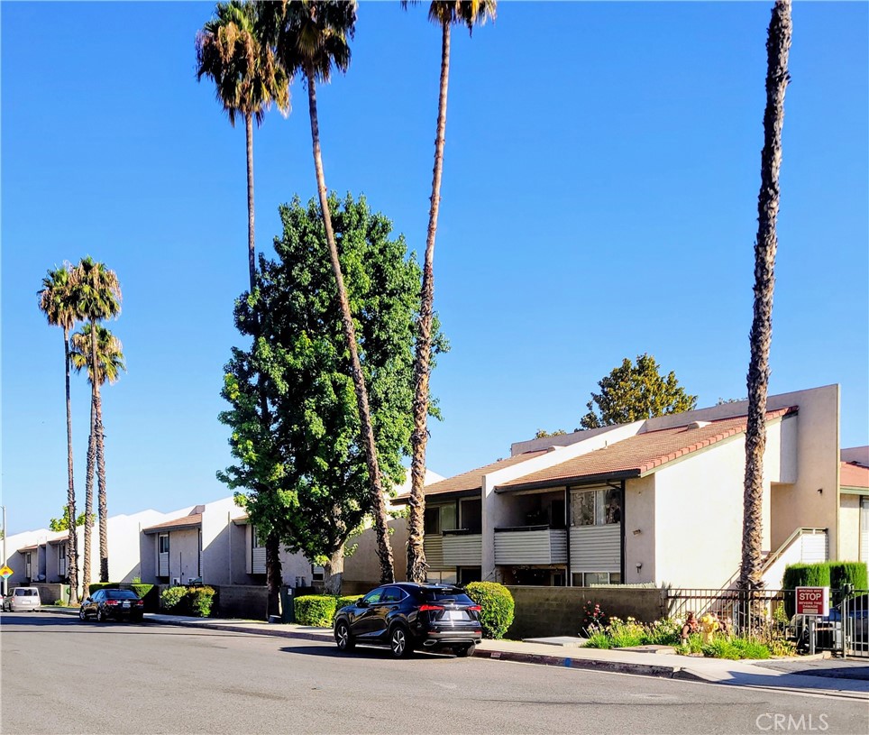 2255 Cahuilla Street, Unit 68 Colton, CA 92324 - Photo 2 of 30 a front view of a house with a garden and trees