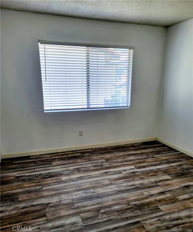 2255 Cahuilla Street, Unit 68 Colton, CA 92324 - Photo 21 of 30 a view of a room with wooden floor and a window