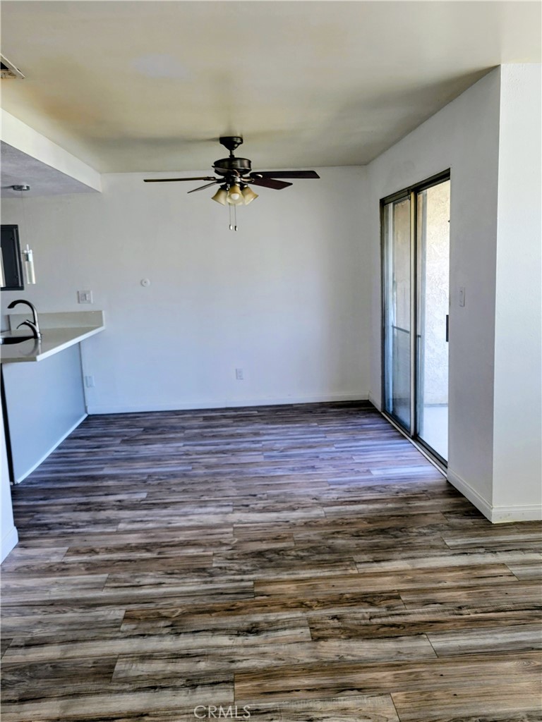 2255 Cahuilla Street, Unit 68 Colton, CA 92324 - Photo 25 of 30 a view of a room with wooden floor and a ceiling fan