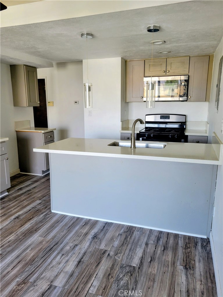 2255 Cahuilla Street, Unit 68 Colton, CA 92324 - Photo 27 of 30 a living room with a couch wooden floor and a table