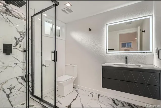 a bathroom with a sink toilet and shower