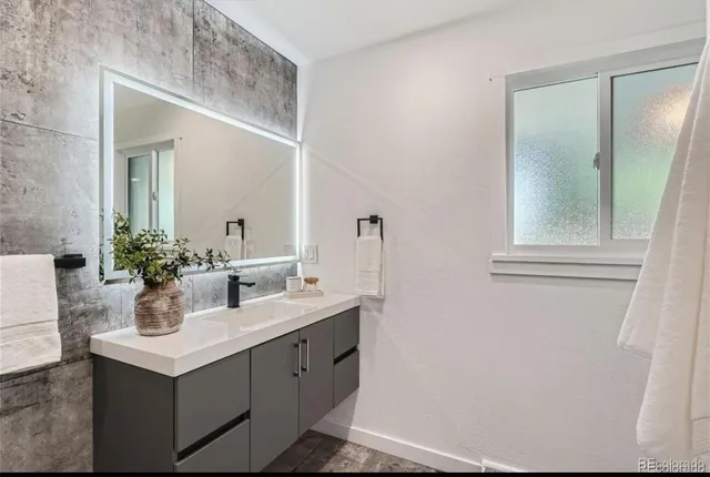 a bathroom with a sink and mirror