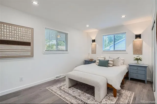 a bedroom with a bed and a lamp