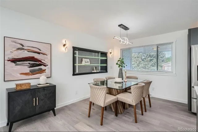 a dining room with furniture and window