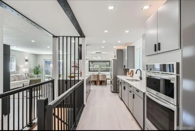 a kitchen with stainless steel appliances kitchen island granite countertop a large stove a sink and a refrigerator