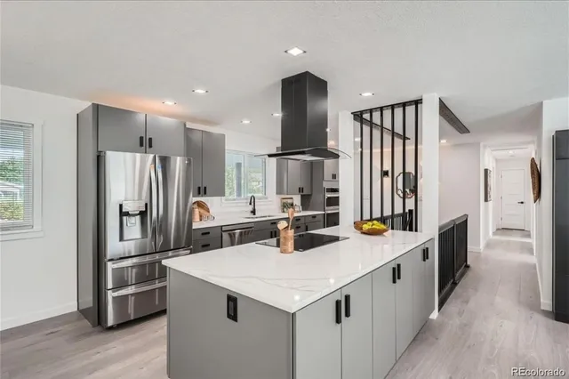 a kitchen with stainless steel appliances a sink and refrigerator
