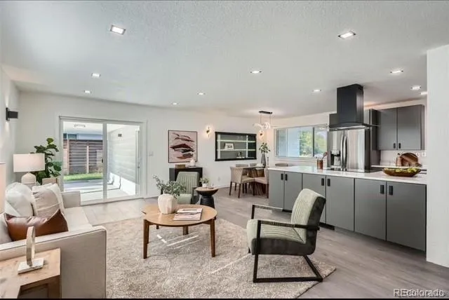 a living room with furniture and kitchen view