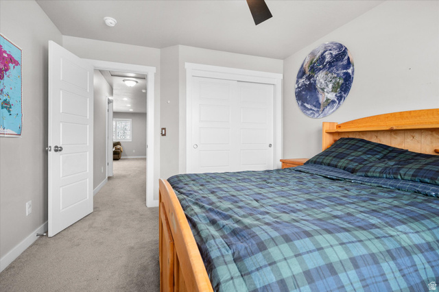 3359 Eurasian Crane Road Clinton, UT 84015 - Photo 36 of 71 Bedroom with light carpet, a closet, and a ceiling fan