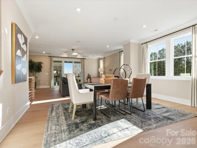 a large white kitchen with a large window a sink and stainless steel appliances