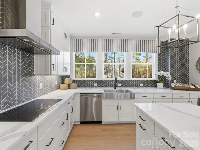 a kitchen with stainless steel appliances a sink and a refrigerator
