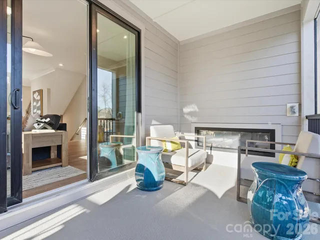 a living room with furniture and a painting on the wall