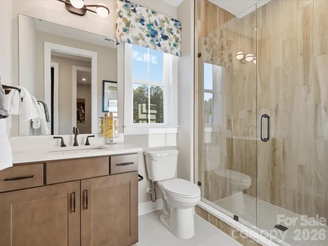 a room with a desk chair and a large window