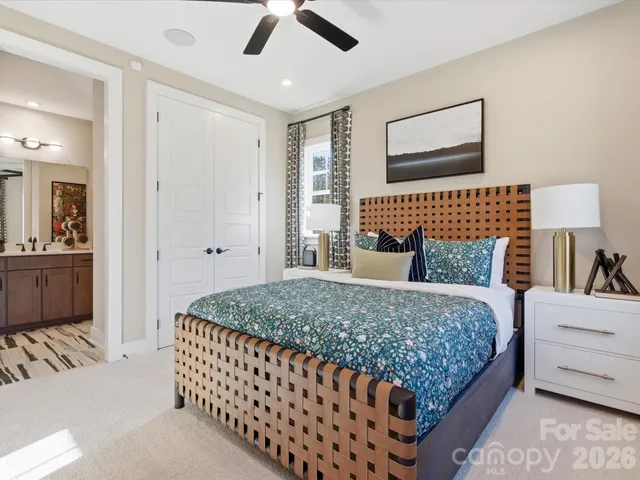 a living room with furniture wooden floor and a large window