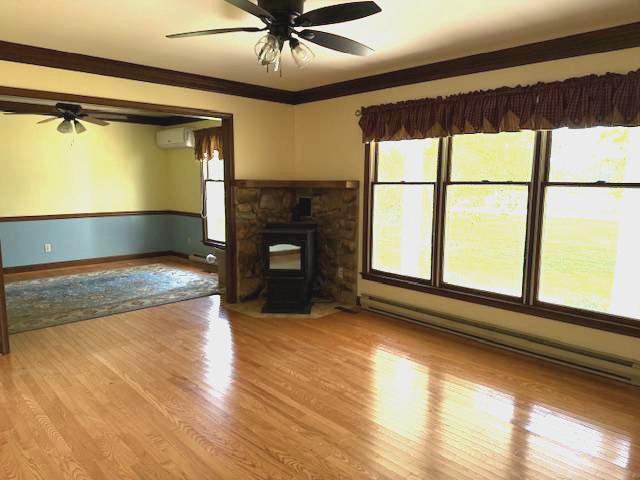 22360 Great Oak Landing Road Chestertown, MD 21620 - Photo 29 of 65 Livingroom with pellet Stove and hardwoods