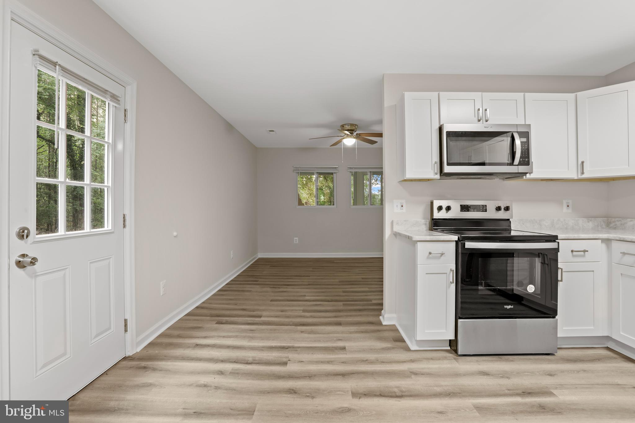 1003 Cedar Hill Road Colonial Beach, VA 22443 - Photo 11 of 25 a kitchen with stainless steel appliances granite countertop a stove and a microwave