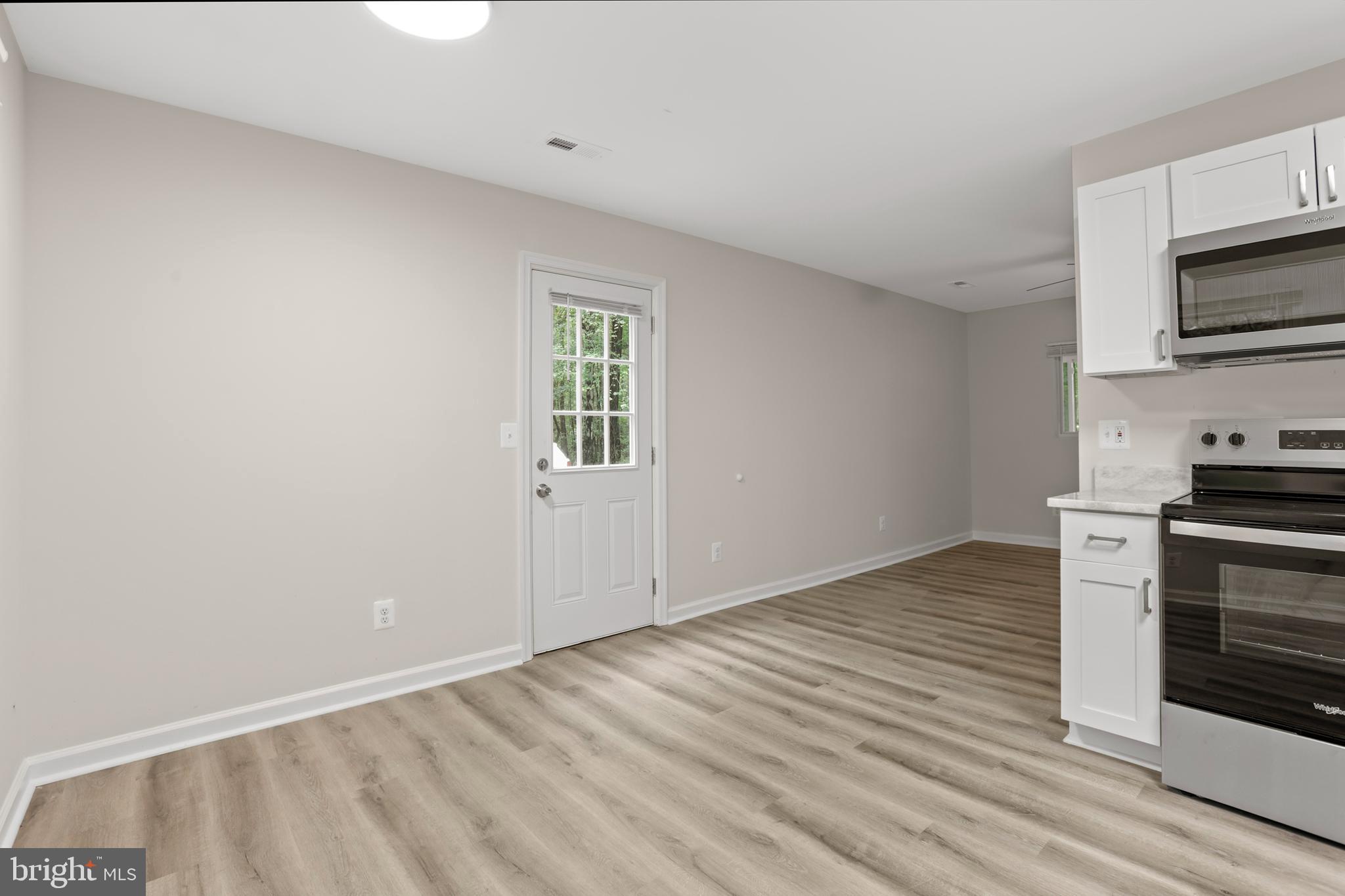 1003 Cedar Hill Road Colonial Beach, VA 22443 - Photo 12 of 25 a view of a kitchen with wooden floor and electronic appliances