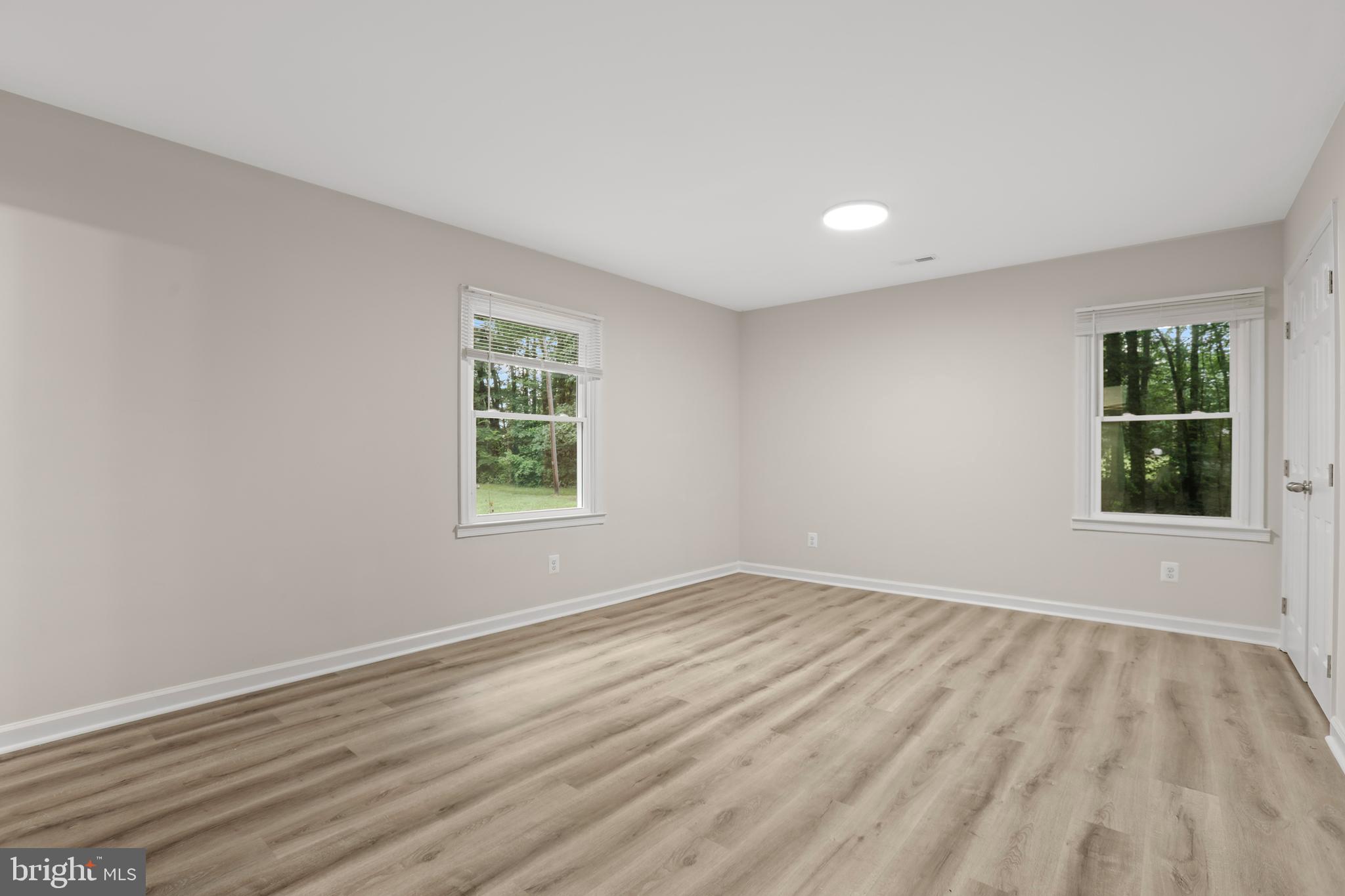 1003 Cedar Hill Road Colonial Beach, VA 22443 - Photo 16 of 25 a view of an empty room with wooden floor and a window