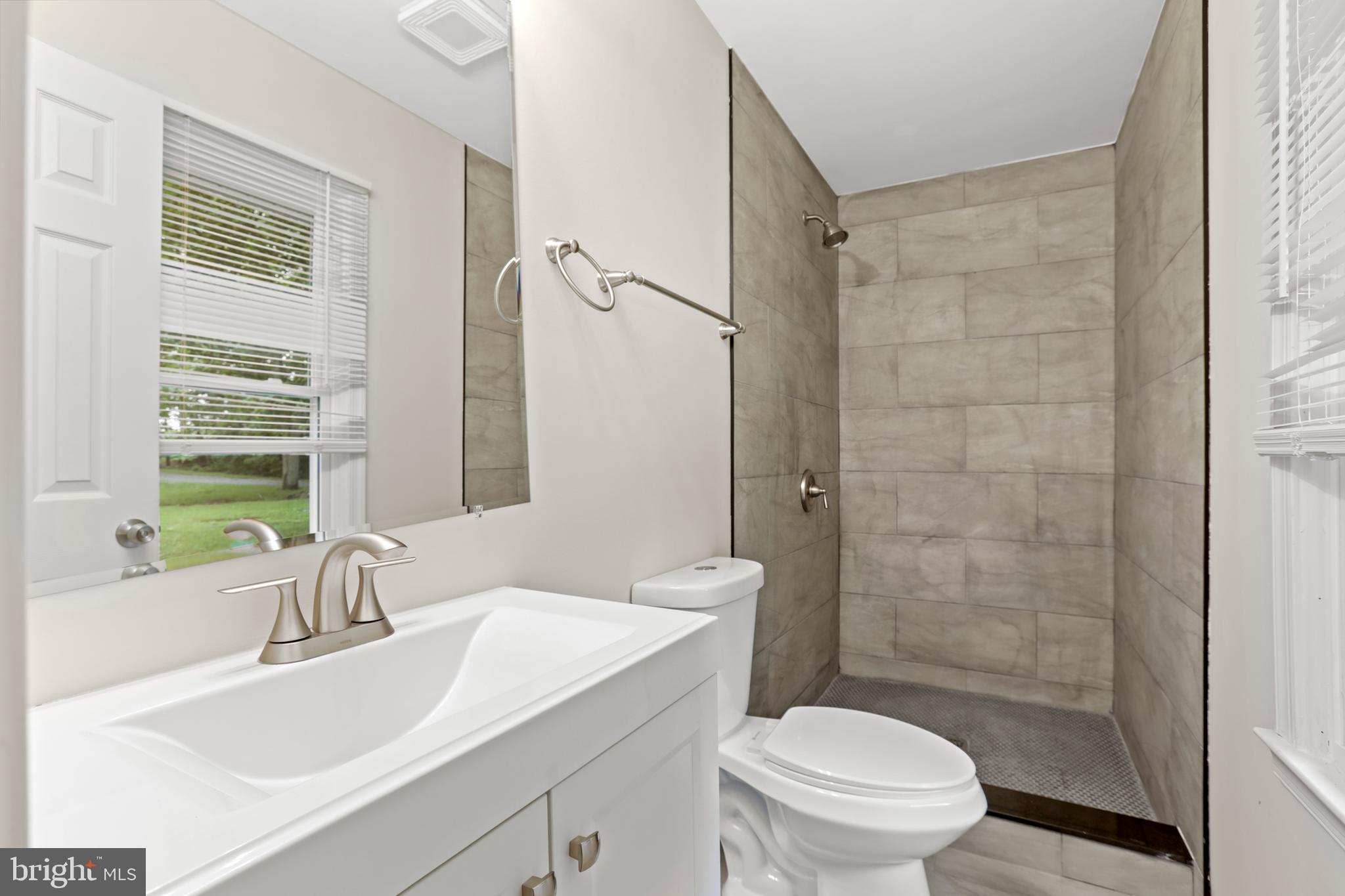 1003 Cedar Hill Road Colonial Beach, VA 22443 - Photo 17 of 25 a bathroom with a sink a toilet and shower