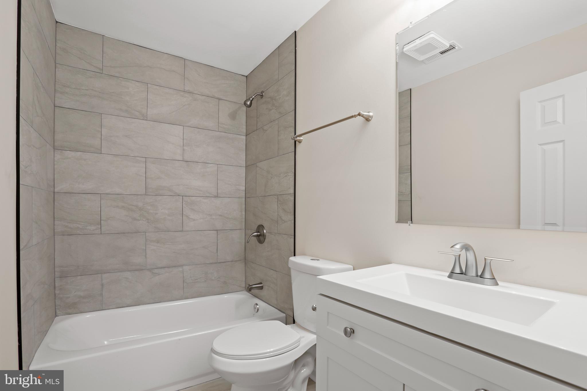 1003 Cedar Hill Road Colonial Beach, VA 22443 - Photo 20 of 25 a bathroom with a bathtub shower sink vanity mirror and toilet
