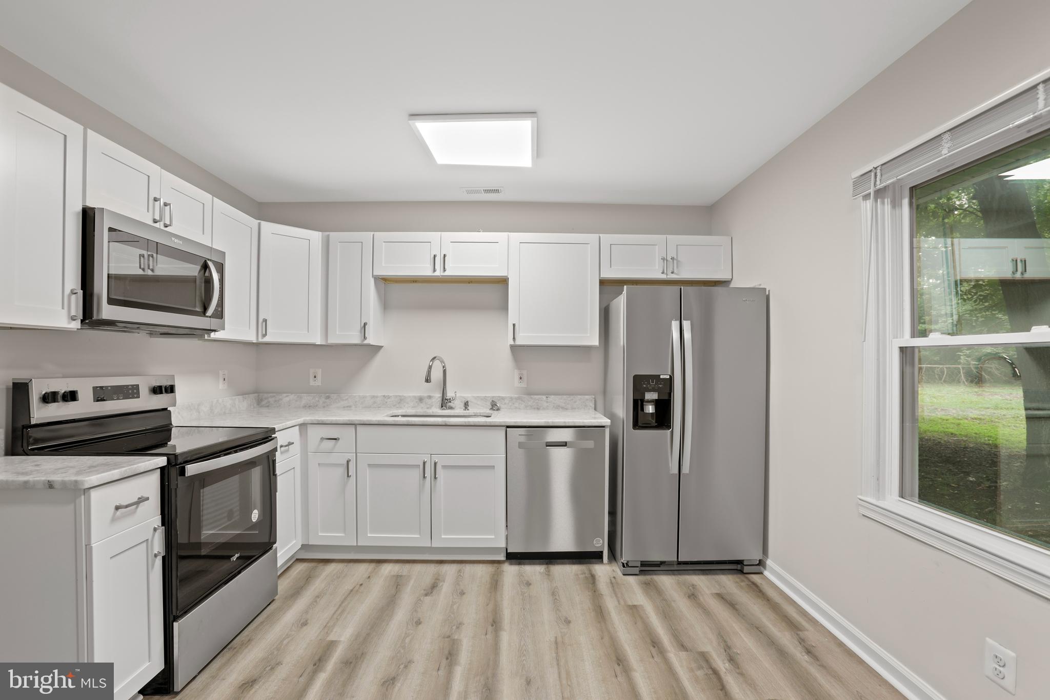 1003 Cedar Hill Road Colonial Beach, VA 22443 - Photo 2 of 25 a kitchen with stainless steel appliances granite countertop a refrigerator sink and stove