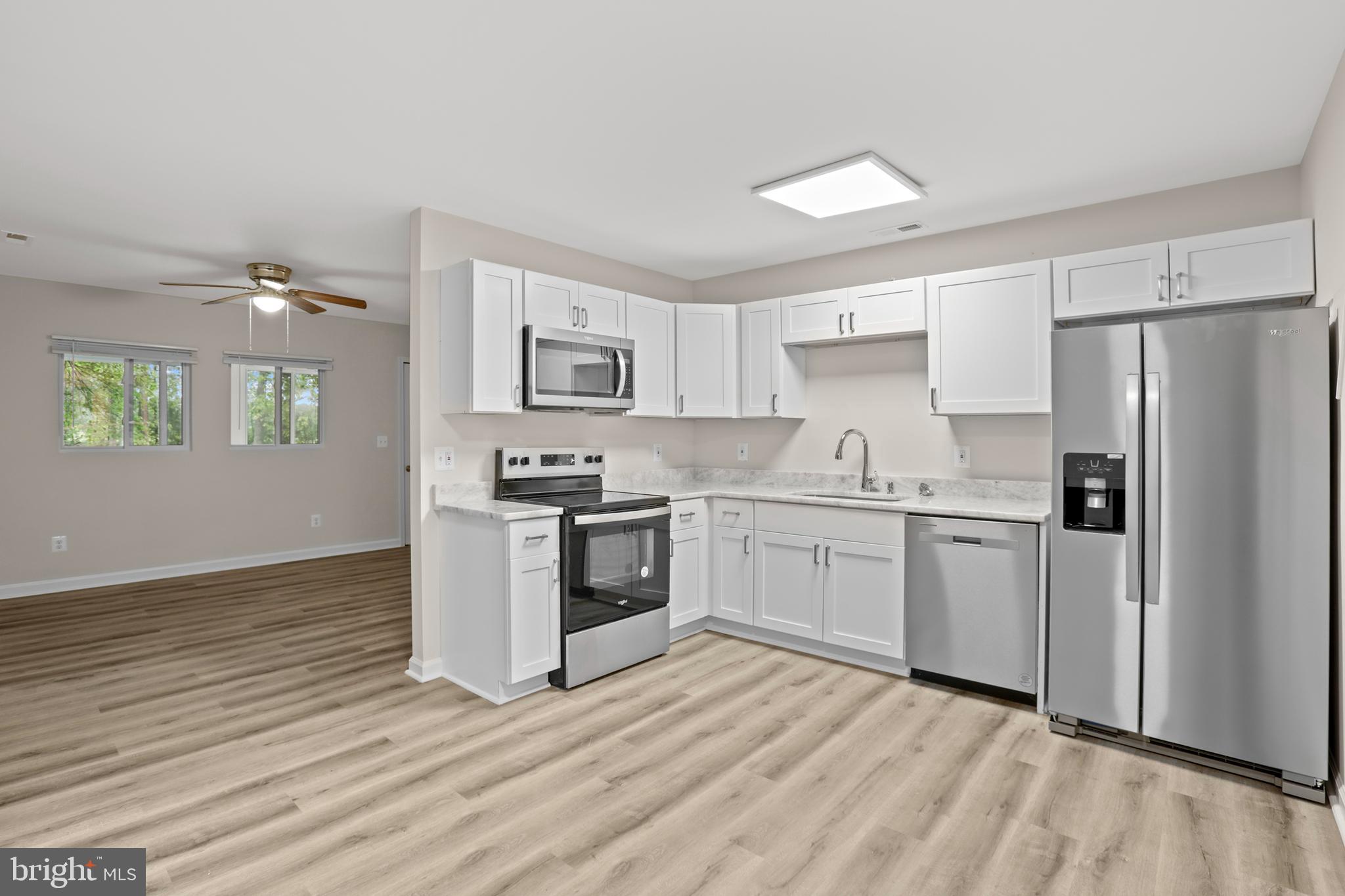 1003 Cedar Hill Road Colonial Beach, VA 22443 - Photo 3 of 25 a kitchen with granite countertop white cabinets and white appliances