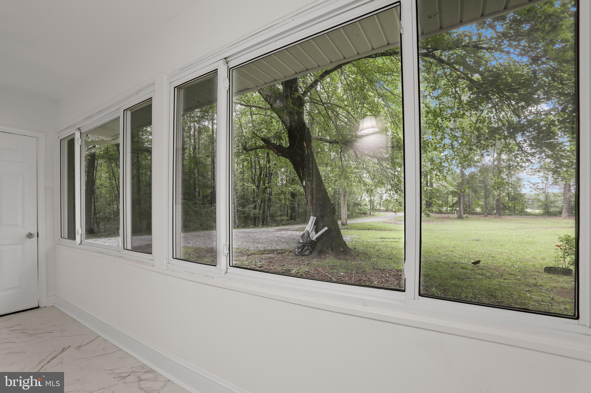 1003 Cedar Hill Road Colonial Beach, VA 22443 - Photo 6 of 25 a view of a glass door and a yard from a window
