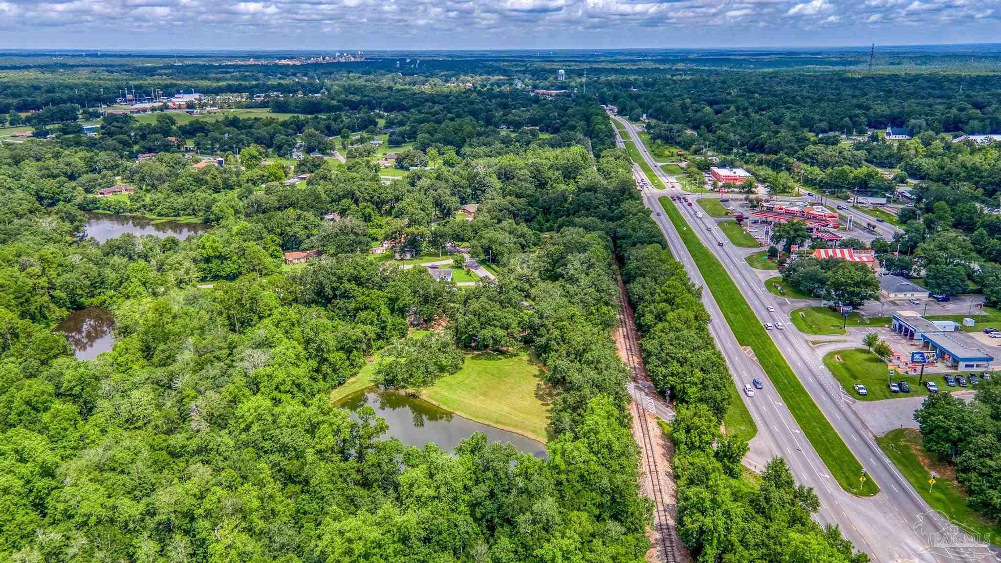 2345 Pompano Street Cantonment, FL 32533 - Photo 26 of 48 a view of a city with lush green forest