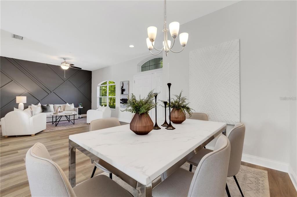 1918 Berry Road Plant City, FL 33567 - Photo 11 of 53 a dining room with wooden floor a chandelier a wooden table and chairs