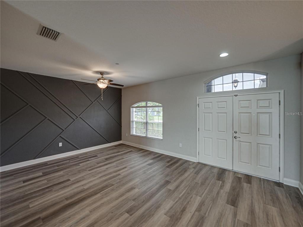 1918 Berry Road Plant City, FL 33567 - Photo 12 of 53 wooden floor in an empty room with a window