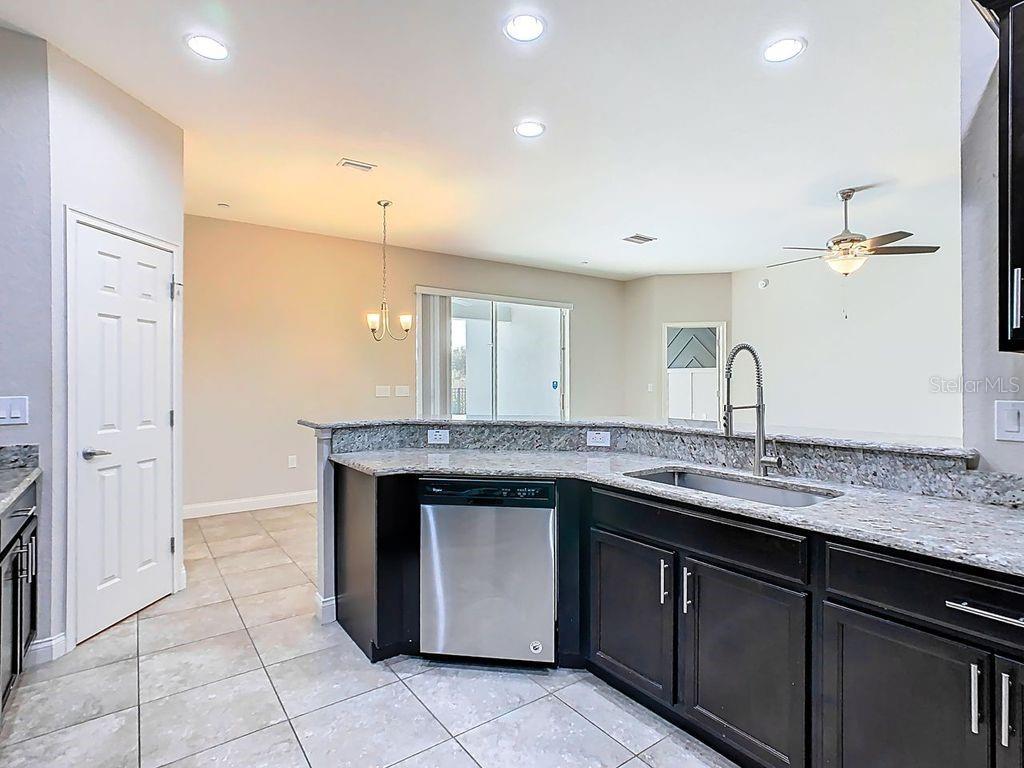 1918 Berry Road Plant City, FL 33567 - Photo 18 of 53 a kitchen with a sink and a refrigerator