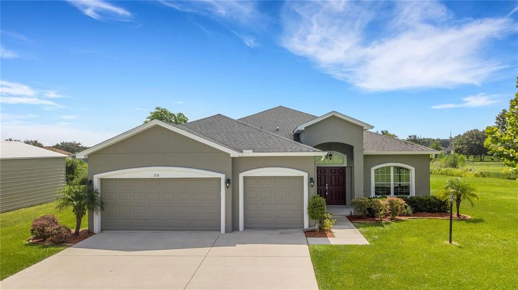 1918 Berry Road Plant City, FL 33567 - Photo 2 of 53 a front view of a house with garden