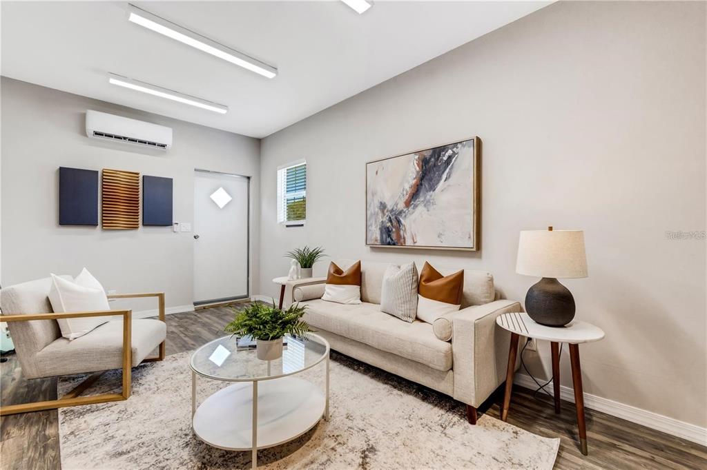 1918 Berry Road Plant City, FL 33567 - Photo 29 of 53 a living room with furniture and a painting on the wall