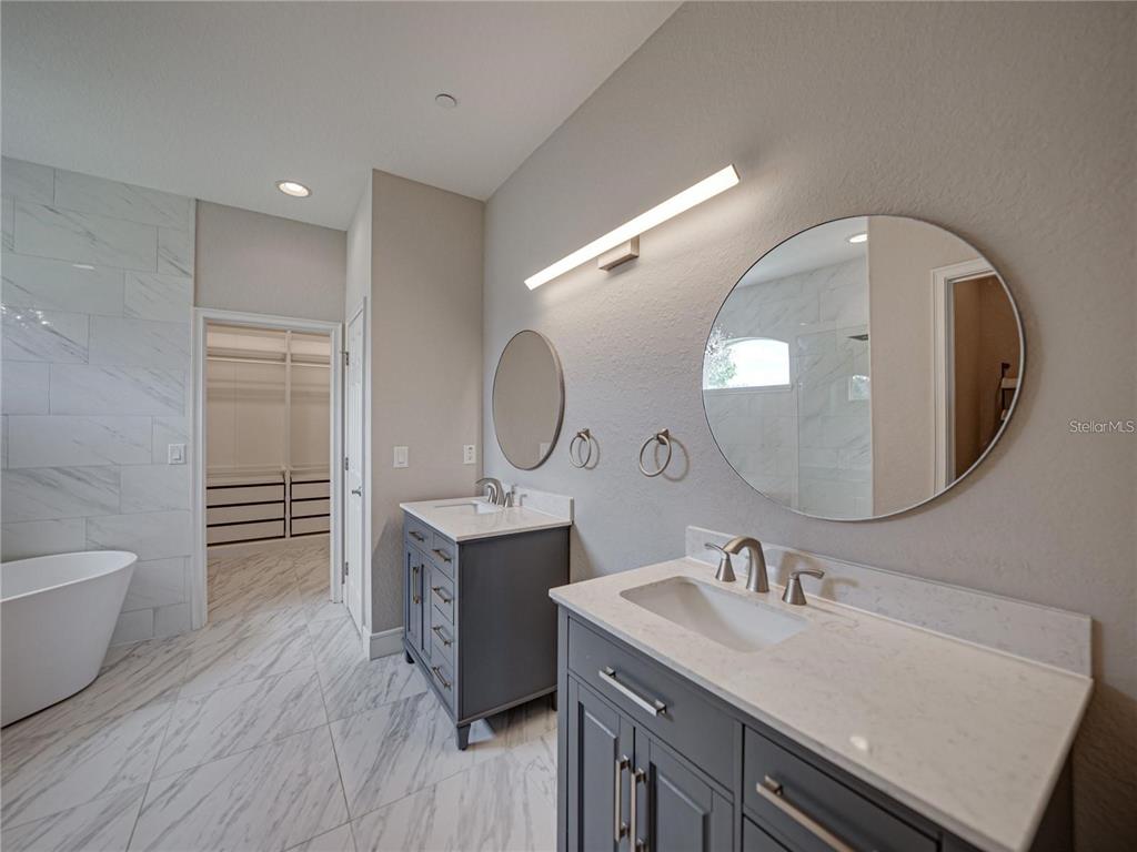 1918 Berry Road Plant City, FL 33567 - Photo 30 of 53 a bathroom with a double vanity sink and a mirror